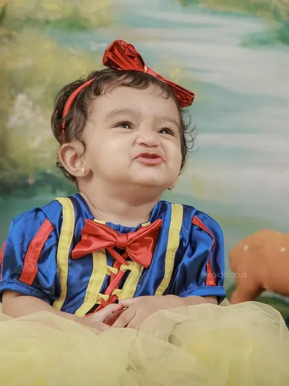 A little princess dressed as Snow White makes a funny face. Our fairytale shoots are all about capturing the playful and magical moments of childhood.
