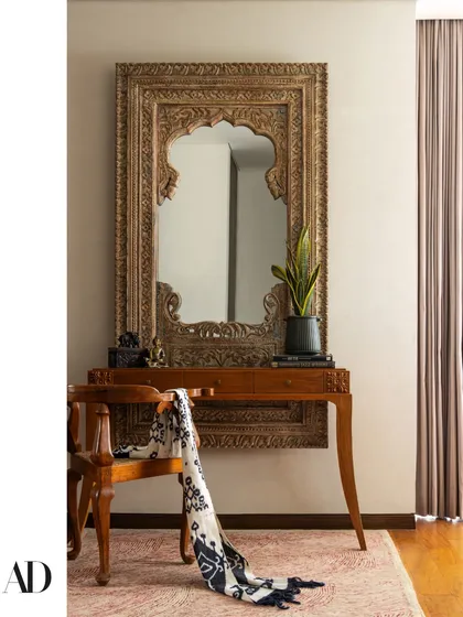 This entryway vignette captures our love for mixing old with new. I paired an intricately carved antique mirror with a clean-lined console to immediately establish the home's narrative. It’s these intentional details and the story they tell that transform a house into a personal retreat.