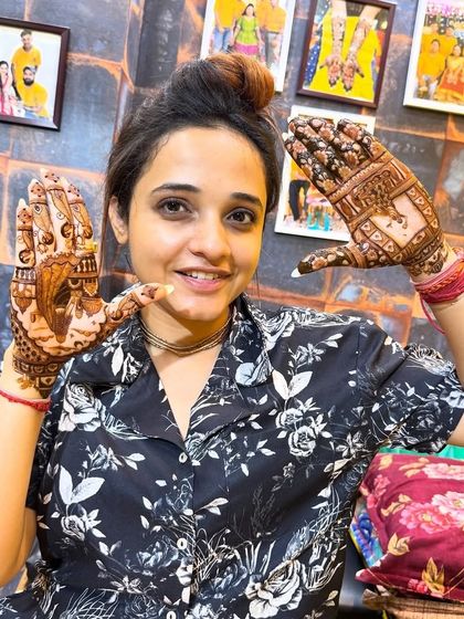 A happy client posing with her intricate Karwa Chauth mehndi. We love seeing our clients so pleased with our work.