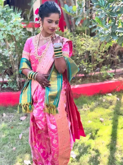 A stunning bride in a pink Paithani saree. I focused on enhancing her beautiful dusky skin tone with a warm, glowing makeup look that made her radiate confidence.