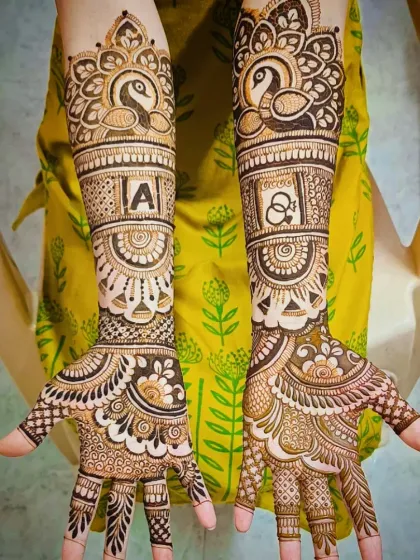I specialize in personalizing your bridal mehandi. Here, I incorporated the groom's initial 'A' and a pair of elegant peacocks, which symbolize beauty and grace in Indian culture.