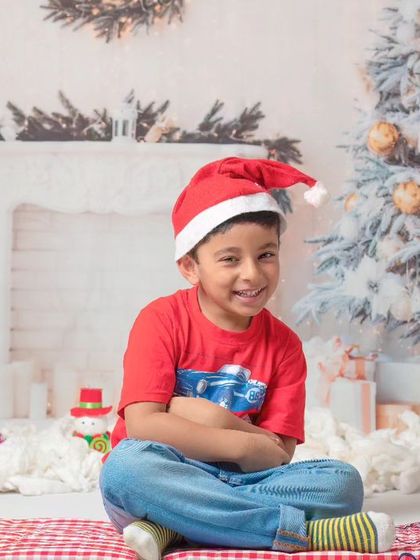 A collection of happy kids enjoying my two distinct Christmas setups: a bright, snowy winter scene and a warm, rustic brick fireplace.