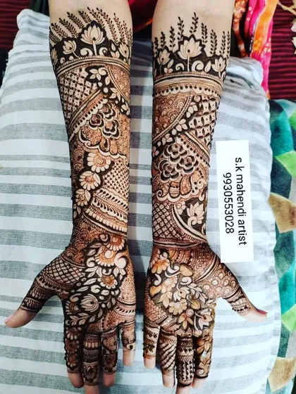 A beautiful example of intricate floral and paisley mehendi. The design covers the full arms with delicate patterns, perfect for a classic bridal look.