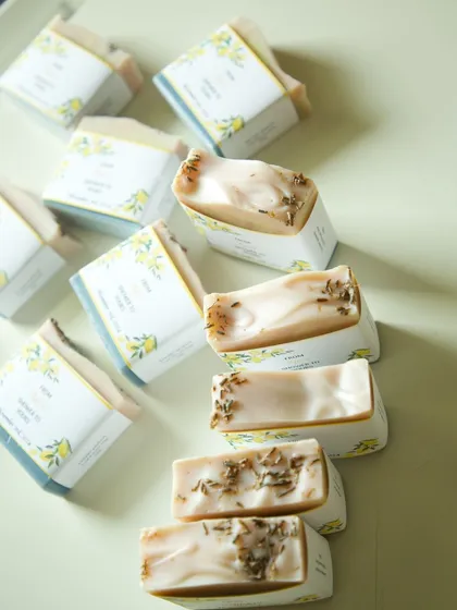The soaps feature natural indigo and clay colors, topped with dried lavender.