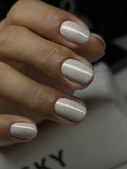 A lovely off-white manicure with a subtle speckled finish, like a quail's egg. This unique texture adds a touch of modern art to a neutral color.
