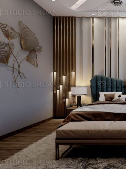 A luxurious bedroom in Alameda, Gurgaon, with a dramatic, backlit wooden feature beside a plush, teal-colored, scalloped headboard.