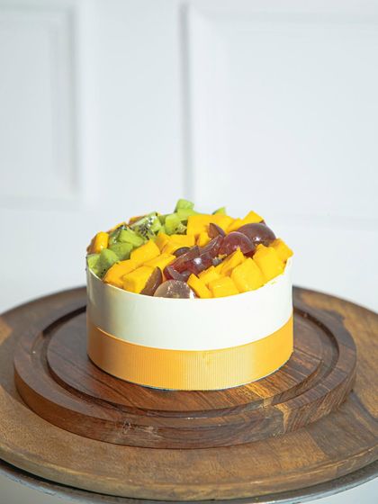 A close-up of our fresh fruit mango cake, highlighting the vibrant colours of summer.