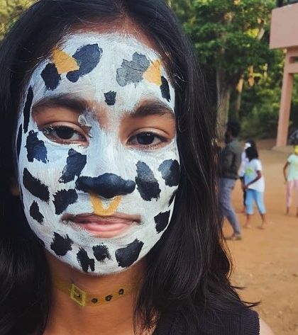 A participant with leopard-spot face paint, ready to join in the camp's jungle-themed fun.