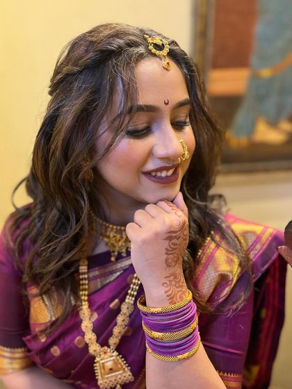 A candid shot showing the bride's happy expression. The makeup is designed to look great both in person and in photographs.