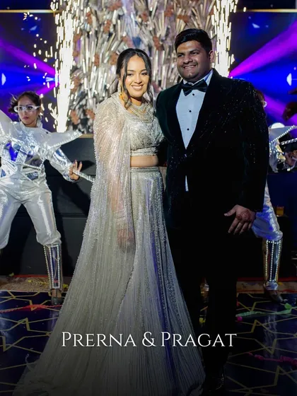 The couple poses with futuristic LED-costumed dancers, adding a high-tech and spectacular entertainment element to their Sangeet night.