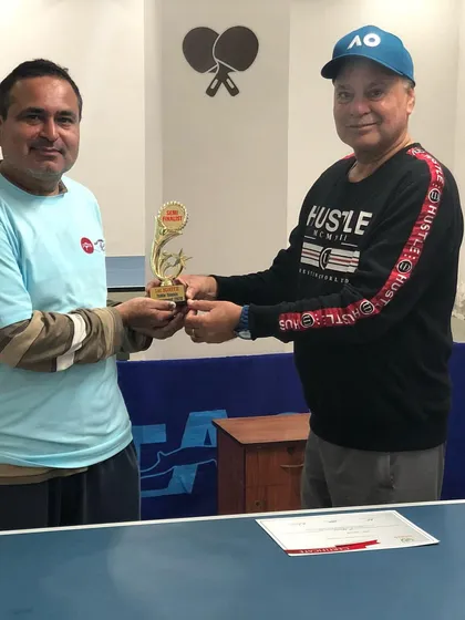 A participant being awarded his trophy for securing a top position. We celebrate the spirit of competition and the hard work of every player who steps up to the table.