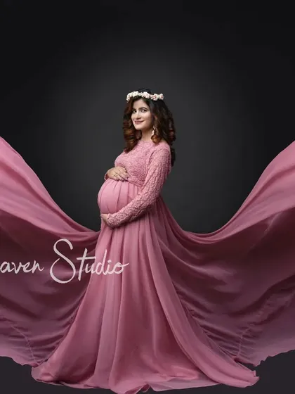 Let your spirit soar. I love using dramatic, flowing designer maternity gowns to create breathtaking silhouettes that celebrate your changing form. This studio shot in a beautiful pink dress captures a feeling of pure elegance and strength.