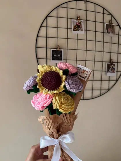 A beautiful pastel bouquet featuring a sunflower and various shades of roses. A reminder that little things aren't little.