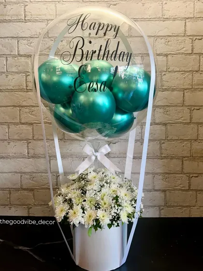 A beautiful birthday Bobo Box created for Eesa. This piece combines fresh white chrysanthemums with shiny teal balloons inside a personalized clear bubble, all set in a clean white box.