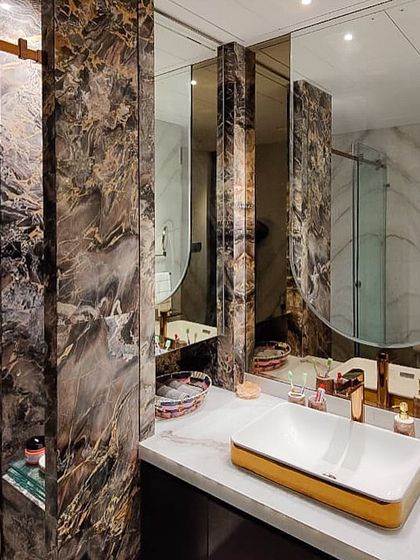A look inside the master bathroom of the Jesrani Residence, where we used dramatic, book-matched marble and rose gold fixtures. The design creates a spa-like feel, blending bold materials with elegant, modern forms for a truly luxurious experience.