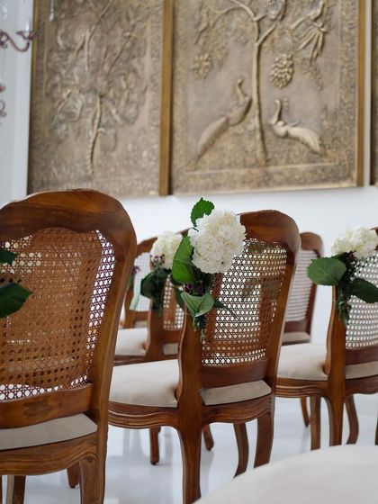 We believe in the beauty of details. For this indoor ceremony, we chose elegant rattan-weaved chairs and adorned them with simple, classic floral arrangements.