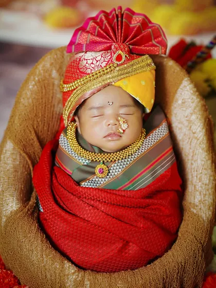 A close-up of the newborn in his festive Gudi Padwa attire, complete with a tiny nose ring and necklace.