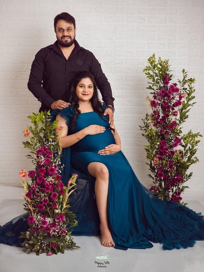 Another beautiful shot from this couple's floral-themed maternity session. This pose highlights her amazing gown and the supportive presence of her partner.