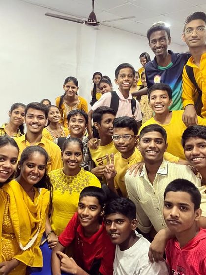 A cheerful group of students dressed in yellow for Day 5 of Navratri 2023.