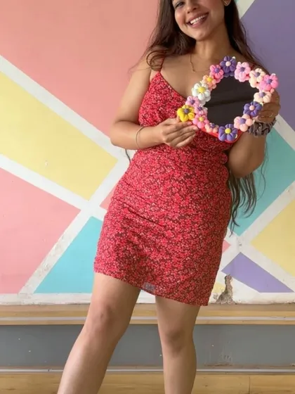A participant happily shows off the decorative mirror she made. Our workshops are all about creating things that make you smile.