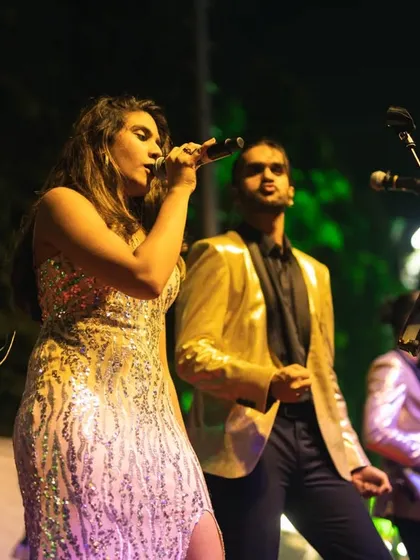 Our vocalists Shanelle and Aryaman performing at a Christmas Eve event. We always dress for the occasion, and the gold jackets added a bit of festive sparkle.