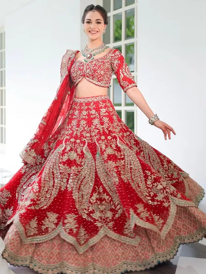 A joyful twirl, showing off the magnificent red lehenga. The makeup is designed to be picture-perfect from every angle, capturing the energy and happiness of the day.