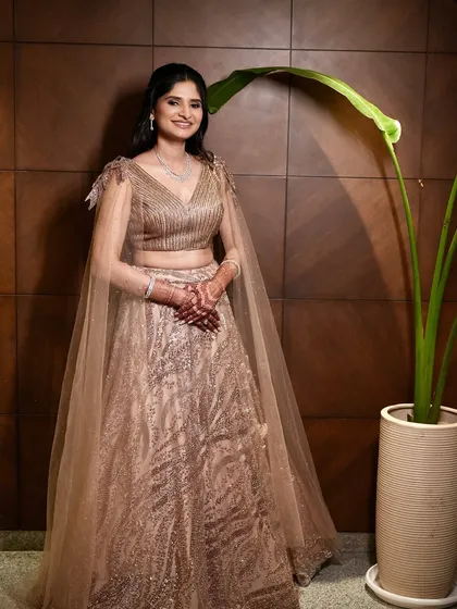 A wide shot showing the beautiful cape detail of her outfit. The makeup is designed to be glamorous yet understated, letting the whole look shine.