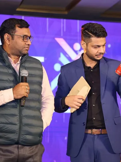 On stage at the World's NRI Meeting 2025, performing an illusion that combines everyday objects with extraordinary magic. It’s all about creating surprise and delight.