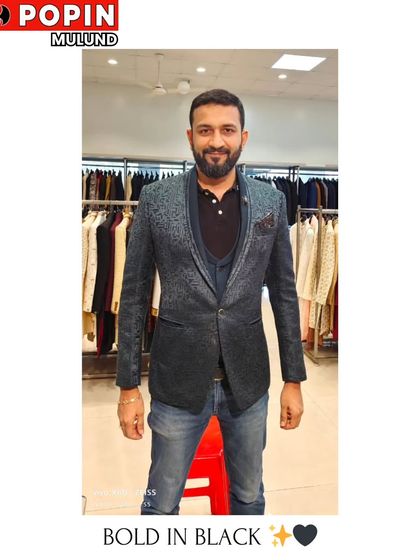 A client trying on a textured black blazer over a polo shirt and jeans. This shows how my blazers can be styled casually for a smart-casual event.