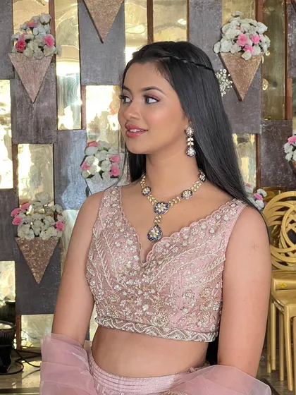 A side profile of this client, showing her sleek hair and glowing makeup.