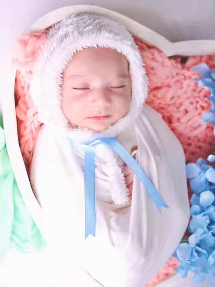A close-up on the "baby bunny," highlighting the soft texture of the bonnet and the baby's peaceful, sleeping face.