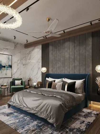 We deliver comfort with luxury in this master bedroom for a Lucknow residence. A deep blue upholstered bed, rich wood flooring, and a stunning crystal ring chandelier come together to create a space that is both cozy and exceptionally stylish.