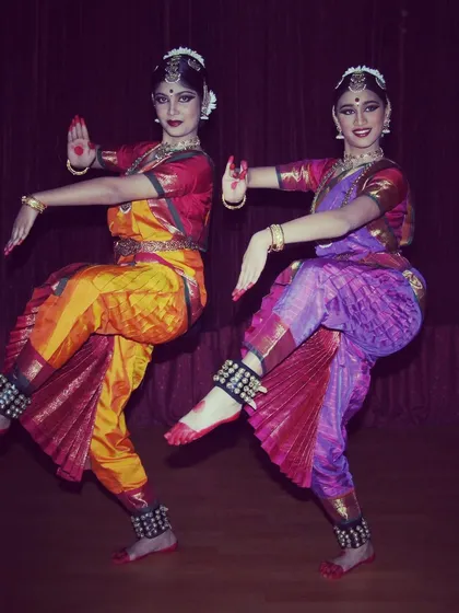 Performing with my fellow student during my Arangetram. The synchronized poses and shared energy on stage are a core part of Bharatanatyam training.