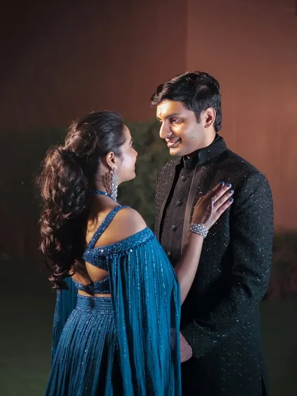 An intimate close-up of the couple, capturing the loving glance between them. The soft lighting highlights the bride's elegant hairstyle and diamond jewelry.