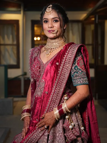 A beautiful portrait of the reception bride. The soft lighting highlights her glowing skin and the intricate details of her velvet lehenga.
