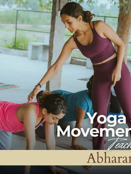 In my workshops, I provide gentle, hands-on guidance to help you find correct alignment and deepen your practice safely. Here, I am assisting a student in a group setting, fostering a supportive space for everyone to grow.