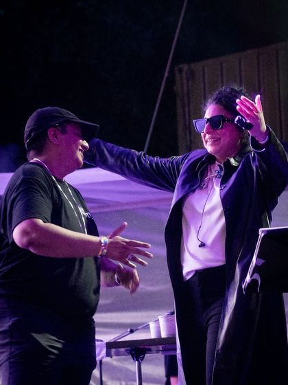 A moment of connection with a fellow artist on stage. The positive energy starts on stage and radiates out into the crowd.