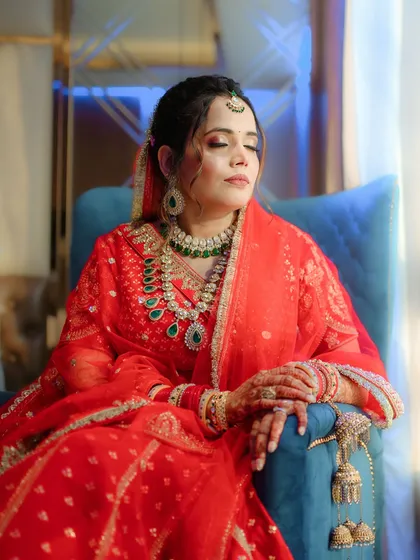 A serene portrait of the bride, resting before her ceremony. The soft lighting highlights her glowing skin and the beautiful details of her jewellery.