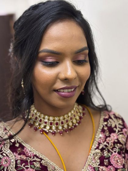 Yamuna looking radiant for her reception. The glowing skin and pink-toned makeup give her a fresh and youthful appearance.