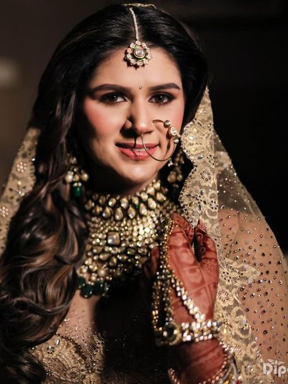 A close-up of a bride's beautiful smile, her hair styled in soft waves.