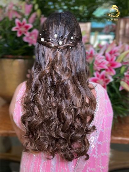A back view of the half-updo, showing the scattered pearls and beautiful curls.