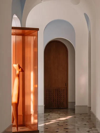 This wooden sculpture, housed in a deep amber glass case, is the 'pièce de résistance' of the main galleria. We placed it strategically to break the circulation spine and spark conversation, proving that art can add immense value and narrative to a space.