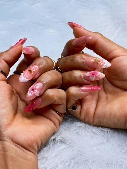 This set combines multiple advanced techniques, including 3D florals, encapsulation, and delicate gold charms, all created by our nail batch students.