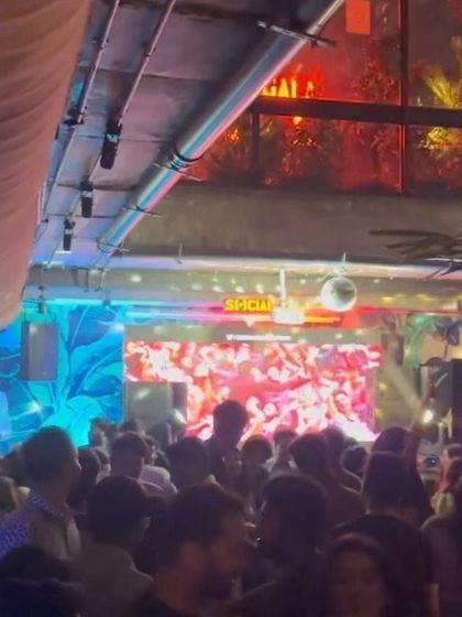A wide shot of the party at Social Koramangala. The venue's unique layout and my audio-visual set create an immersive experience for everyone.