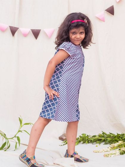 Posing with style in a modern print dress. The combination of stripes and a quatrefoil pattern gives this simple A-line dress a contemporary and fashionable edge.