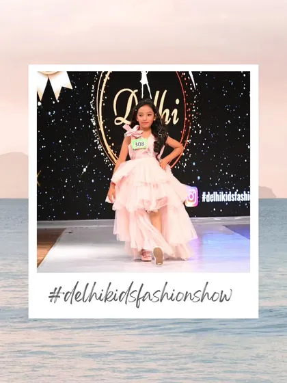 A flowing pink gown with a high-low hemline creates a dramatic and beautiful effect on the runway. I love seeing kids express themselves through elegant and fun fashion choices.