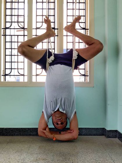 A variation of Rope Shirshasana, moving into Baddha Konasana (Bound Angle Pose) legs. This combines the benefits of an inversion with a deep hip opening.