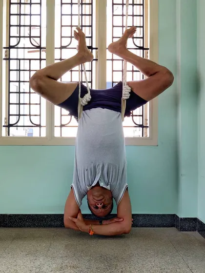 A variation of Rope Shirshasana, moving into Baddha Konasana (Bound Angle Pose) legs. This combines the benefits of an inversion with a deep hip opening.