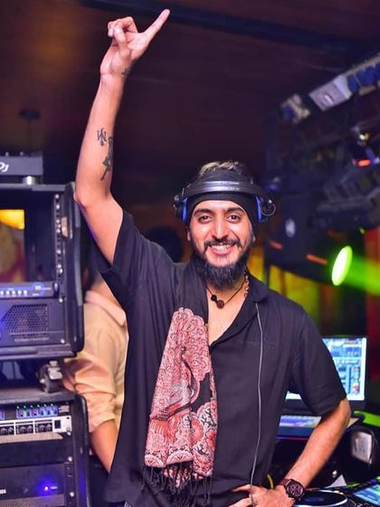 One hand up, celebrating the music. This pose captures the joy and energy I feel during every set.