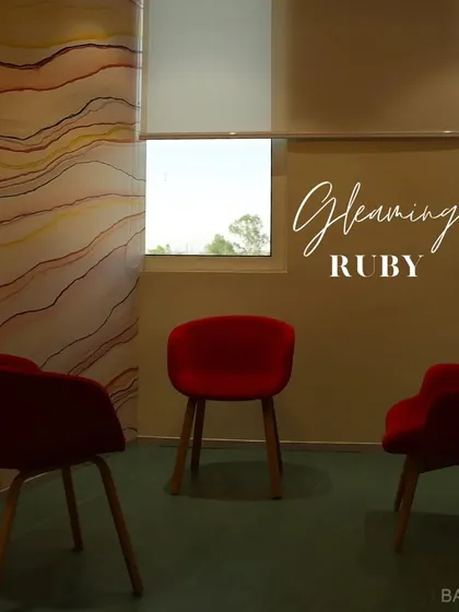 Get bold with BareBase. These gleaming ruby-red chairs make a strong statement against a wall with abstract, flowing lines.
